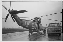 Helicopter and its Navy crew 